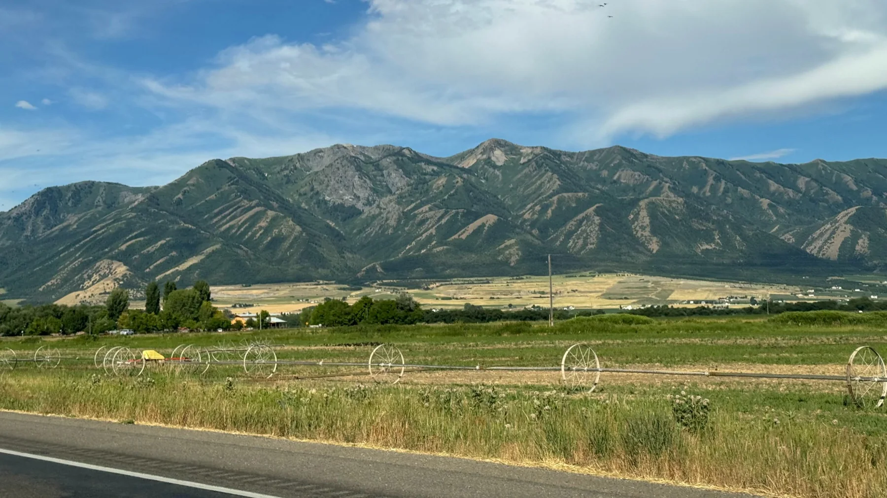 Summer farmland below the mountains
